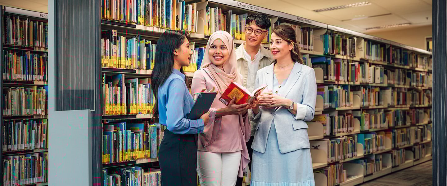 Malay Girl Holding a Red Book with 4 Friends in a Library