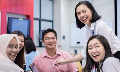 Smiling and Laughing Group of 4 Adults, Classroom with a Young Female Teacher in White Shirt Bob Hair (720x432px)