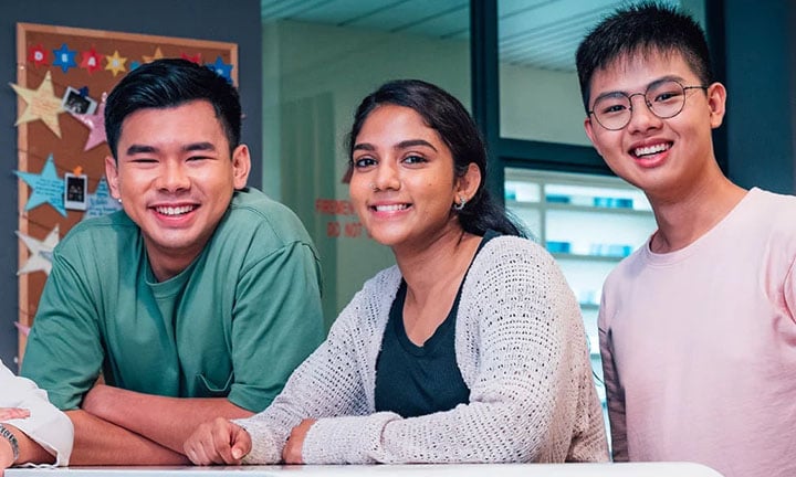 Smiling Group of 3 Young Adults Stars On Classroom Wall (720x432px)