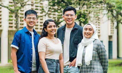 Smiling Group of 4 Young Students at NIE Campus Malay Girl White Tudung Grey GinghamTop (720x432px)