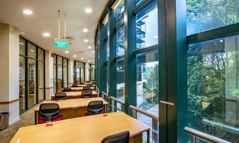 NIE Library with glass window beside table