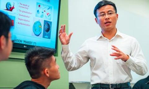 NIE Teacher teaching from slides