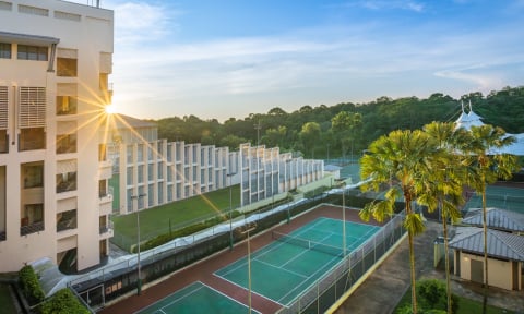 NIE tennis court side view with sunshine