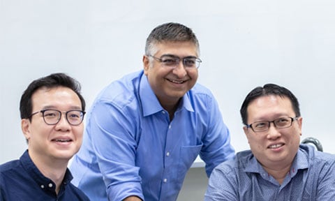 Smiling Group 3 Male Teachers All In Blue In Classroom Looking In Distance (480x288px)