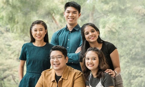Smiling Group A Photo Studio Backdrop Of Trees and 5 Diverse Students Malay Girl Wearing White Dungaree (480x288px)