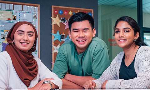 Smiling Group of 4 Young Adults Stars On Classroom Wall Malay Girl with Brown Tudung (480x288px)