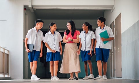 Walking Chinese Lady Teacher Red Top Ivory Skirt Walking Along School Campus With Group Of 4 Secondary Students In School Uniform (480x288px)